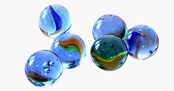 Six marbles against a plain backdrop