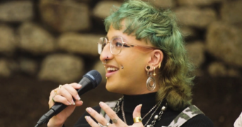 Jasmine Isa Qureshi, a Marine Biologist, speaking into a microphone