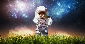 Astronaut in a grass field