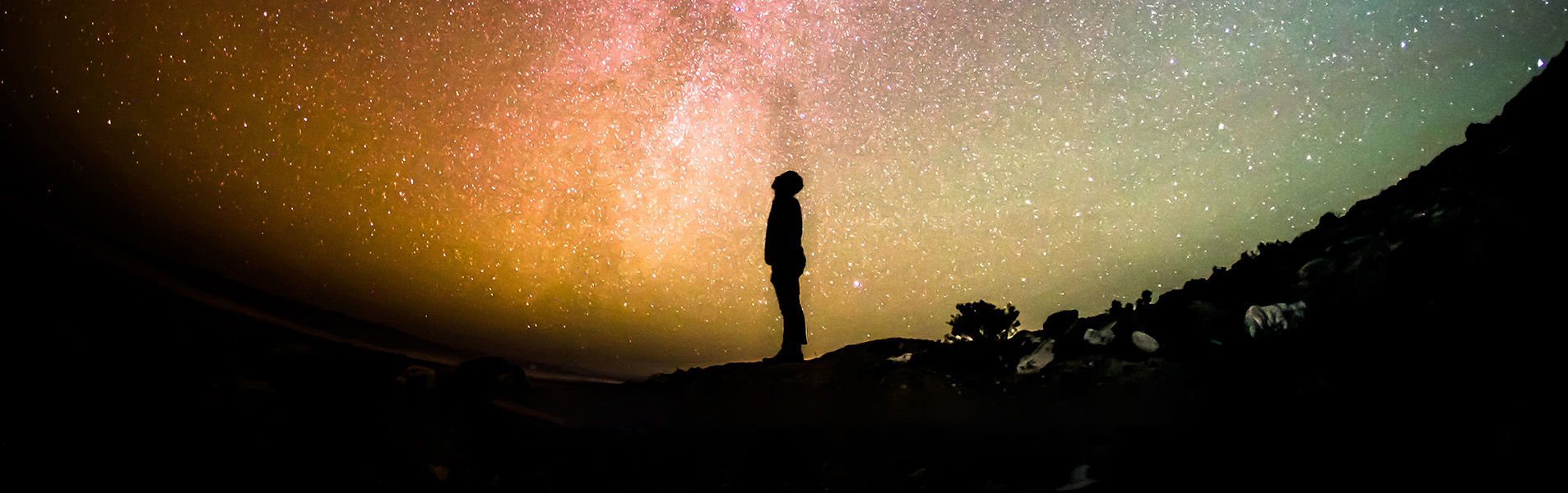 Silhouette of figure in front of planet