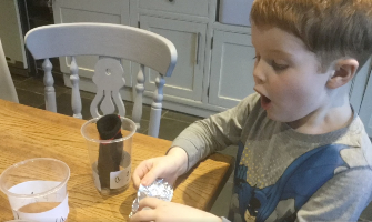 child conducting a a science investigation at home