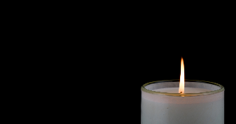 an image of a lit candle surrounded by darkness