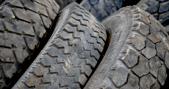 a close of image of rubber tyres leaning against each other on a slant