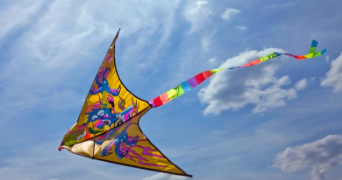 a colourful kite flying in the sky