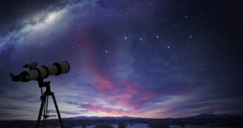 an image of a telescope pointed at a vast purple night sky with stars and clouds in the distance