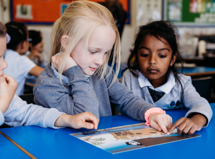 young learned focussed on an image at their desk during class time