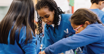 JES issue 23 cover of three upper primary children engaged in science learning